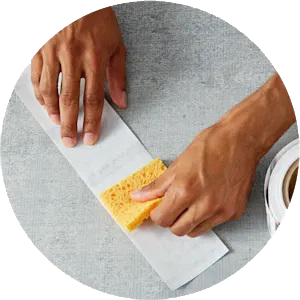 To activate the adhesive, wet the enclosed sponge with water. Then, run the damp sponge on the non-printed side of the tape. You can also use an electric water-activated dispenser or a manual gummed-tape dispenser for this step.